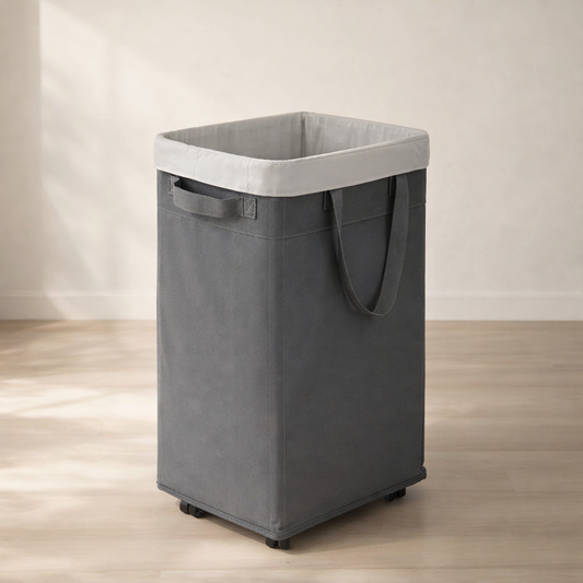 Gray laundry basket with a white lid on a wooden floor.
