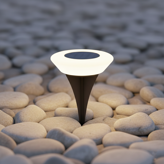 Solar-powered outdoor light on pebbles with a blurred natural background
