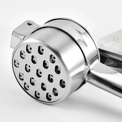 Close-up of a metal hand grinder on a white background