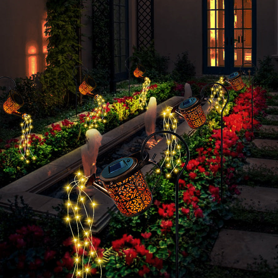 Decorative outdoor scene with solar lanterns and string lights in a garden.