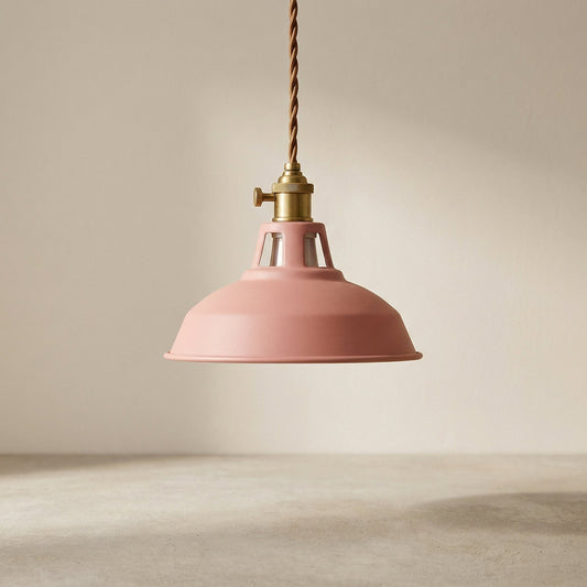 Pink pendant light with brass fitting on a neutral background