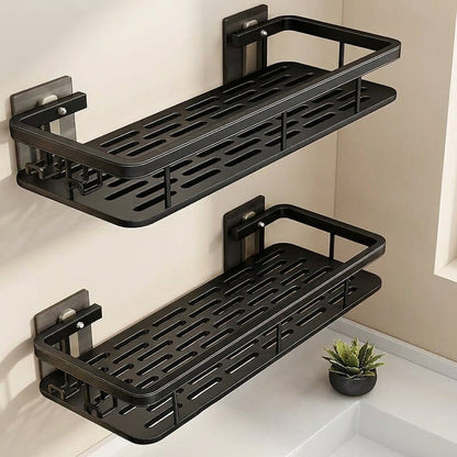 Two black wall-mounted shelves in a bathroom setting with a small plant.