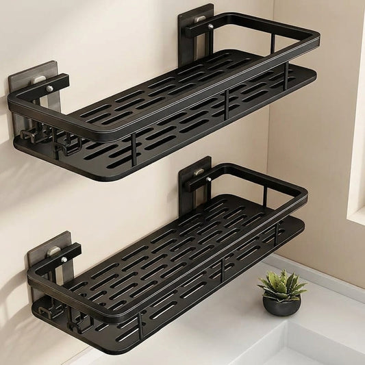 Two black wall-mounted shelves in a bathroom setting with a small plant.