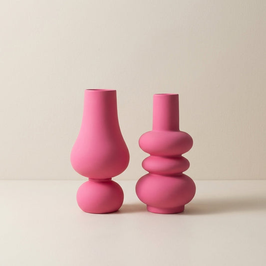 Two pink vases on a beige background
